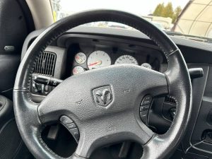 Steering wheel for the truck showing the Dodge Ram logo.