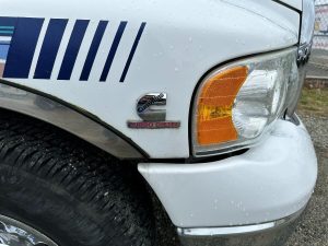 Front passenger light and decal of truck showing "Cummins Turbo Diesel"