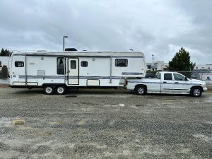 Side view of 1993 Travel Supreme with truck.