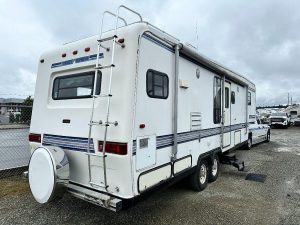 Back/side exterior view of 1993 Travel Supreme showing door.