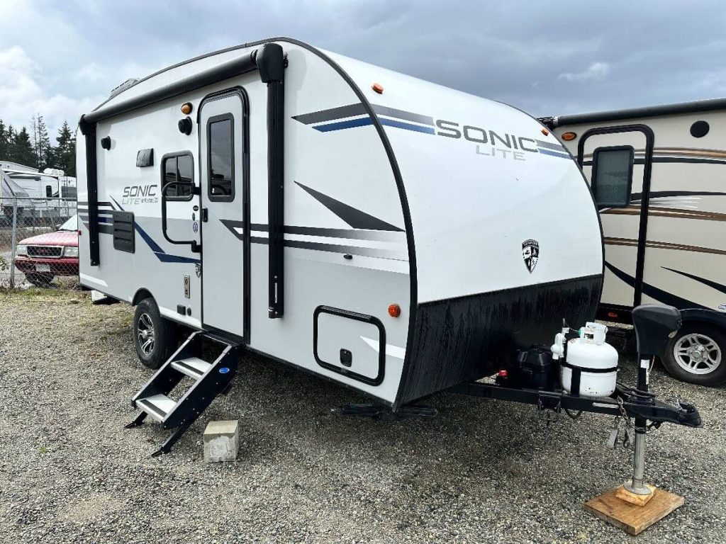 Exterior of Sonic Lite RV showing exterior door and hitch.
