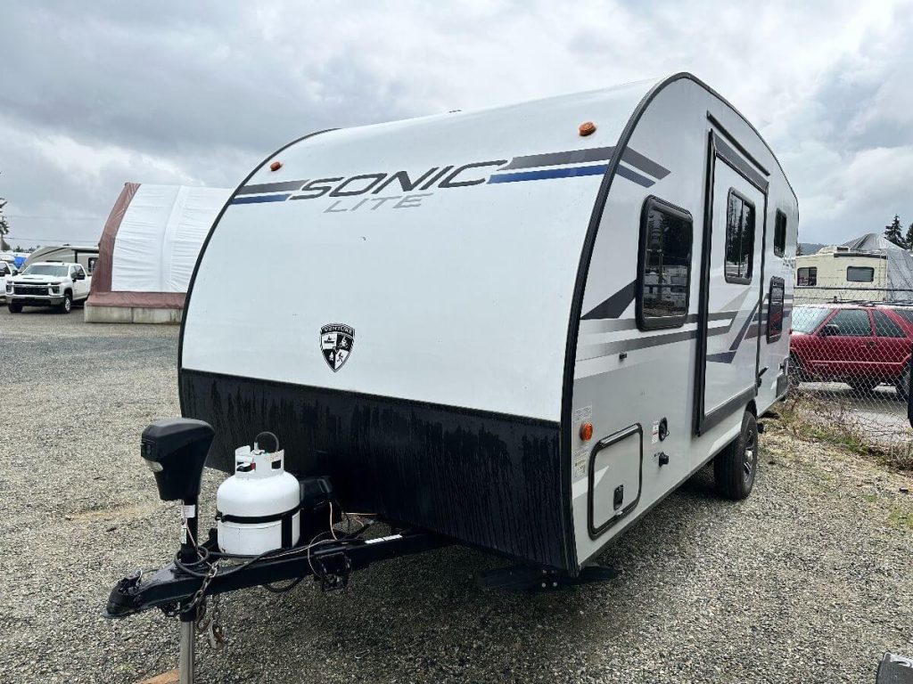 Exterior hitch/side view of RV showing slideout (pushed in)