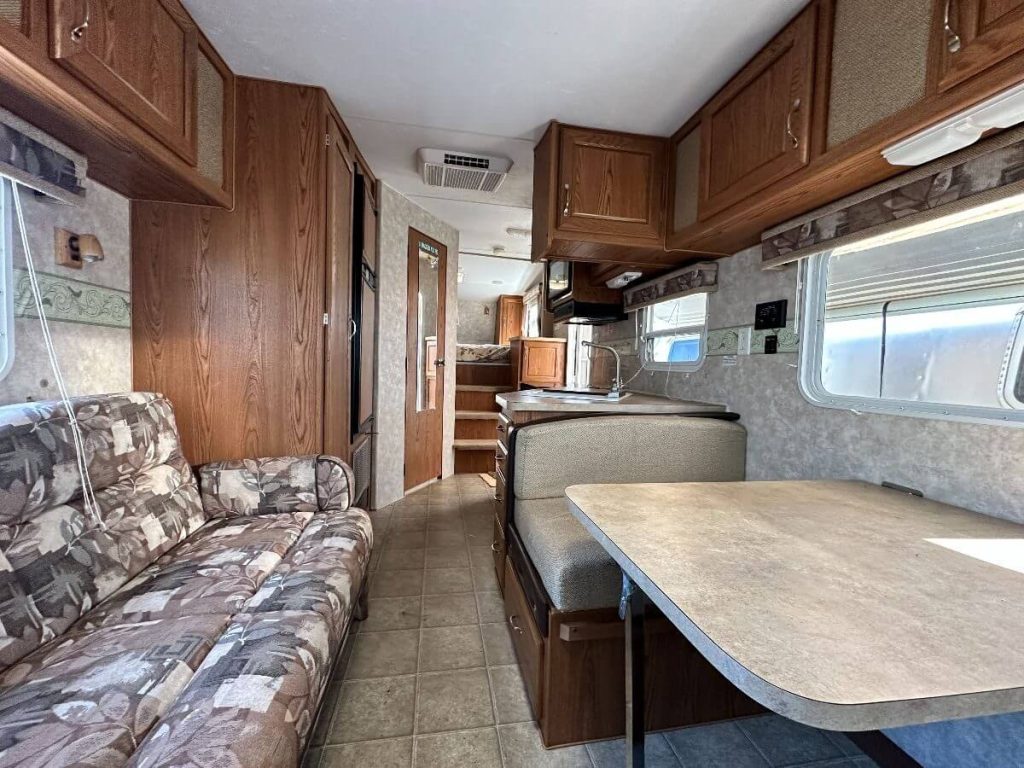 Alternative view of interior of RV from dining area looking towards back bedroom.